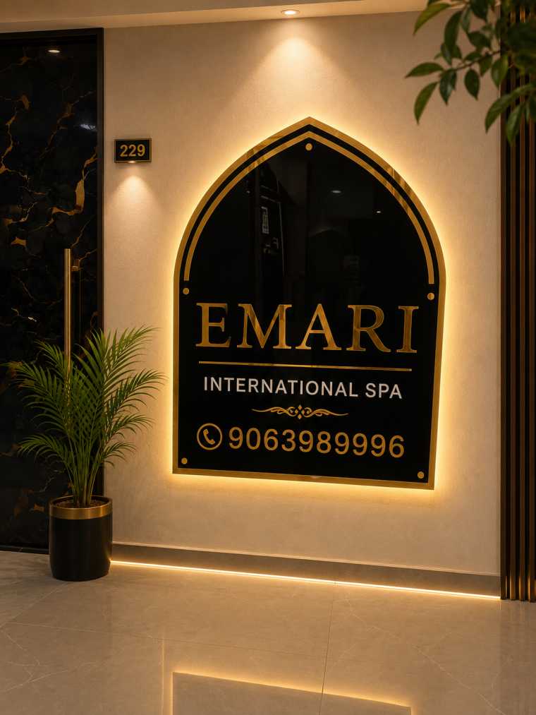 Certified therapist performing hot stone massage at Emari International Spa